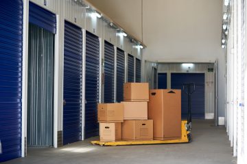 Storage in an industrial building for rental to entrepreneurs or individuals with recyclable cardboard boxes on top of a pallet rack